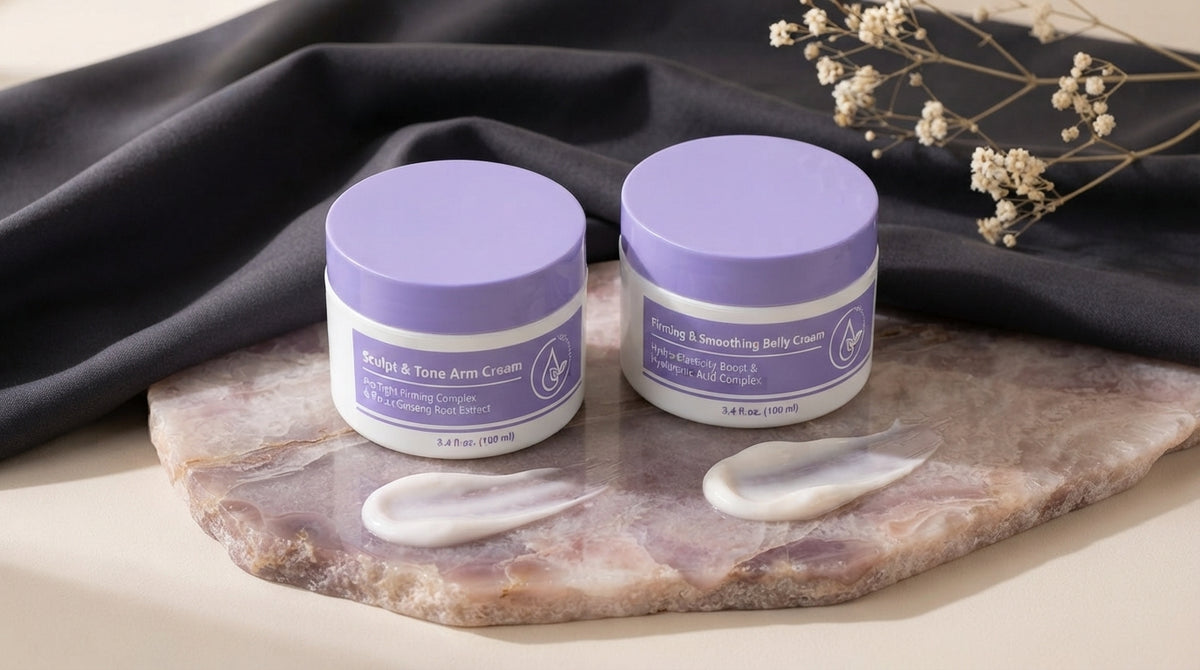 Soft Season Arm Cream and Vyral Belly Cream jars displayed on a pale mauve surface with charcoal fabric accents.